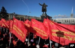 Communists gather near a statue of Soviet Union founder Vladimir Lenin during celebration of the 100th anniversary of the 1917 Bolshevik revolution in St. Petersburg, Russia, Nov. 7, 2017.