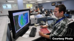 A Walmart meteorologist at his station in the disaster operations center checking on Sandy's progress (Walmart)
