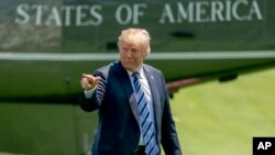 President Donald Trump points to members of the media as he arrives on the South Lawn of the White House in Washington, May 25, 2018. Trump accused The New York Time of using a "phony source" who turned out to be a White House official briefing several re