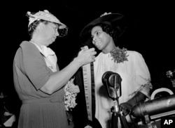 FILE - First lady Eleanor Roosevelt appears with opera singer Marian Anderson in Richmond, Virginia July 2, 1939, as Anderson is presented with the Spingarn Medal. to the singer. (AP Photo, File)