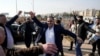 FILE - Men just released from prison dance at the entrance of Aleppo city, on Dec. 9, 2024, as people wait for the return of relatives after the release of detainees from Syrian government prisons following the ousting of Syria's president.