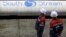 Employees stand near pipes made for the South Stream pipeline at the OMK metal works in Vyksa in the Nizhny Novgorod region, April 15, 2014. 