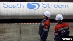 FILE - Employees stand near pipes made for the now-abandoned South Stream pipeline at the OMK metal works in Vyksa in the Nizhny Novgorod region of Russia, April 15, 2014. 