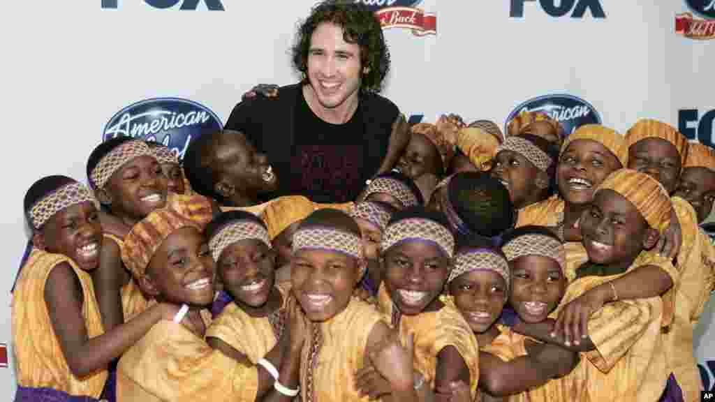 Josh Groban, center, poses with the African Childrens Choir in the photo room at the "Idol Gives Back" fundraising special of "American Idol" in Los Angeles on Wednesday, April 25, 2007