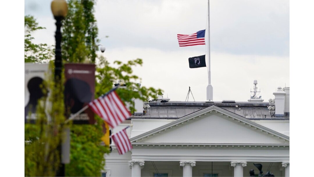 The American flag flies at half-staff over the White House in Washington, April 16, 2021.