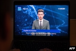 This photo illustration shows a man watching an artificial intelligence (AI) news anchor from a state-controlled news broadcaster, on his computer in Beijing, Nov. 9, 2018.