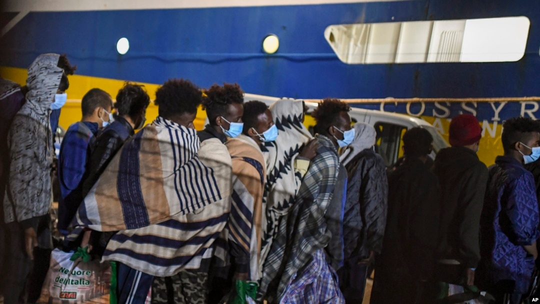 FILE - Some 80 unaccompanied minors from the island of Lampedusa's migrant housing center, Sicily, are embarked on the ship Cossyra, Wednesday, May 12, 2021, bound to the Sicilian town of Porto Empedocle.
