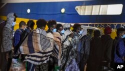 FILE - Some 80 unaccompanied minors from the island of Lampedusa's migrant housing center, Sicily, are embarked on the ship Cossyra, Wednesday, May 12, 2021, bound to the Sicilian town of Porto Empedocle.