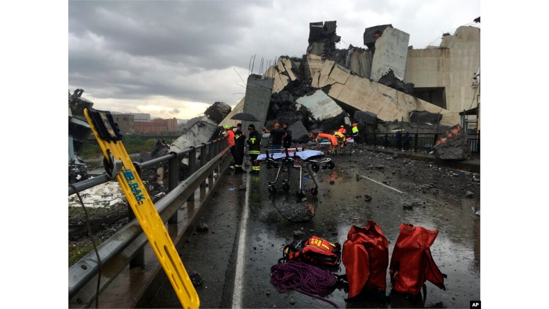 Cars are blocked on the Morandi highway bridge after a section of it collapsed, in Genoa, northern Italy, Aug. 14, 2018. A large section of the bridge collapsed over an industrial area in the Italian city during a sudden and violent storm.