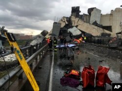 Cars are blocked on the Morandi highway bridge after a section of it collapsed, in Genoa, northern Italy, Aug. 14, 2018. A large section of the bridge collapsed over an industrial area in the Italian city during a sudden and violent storm.