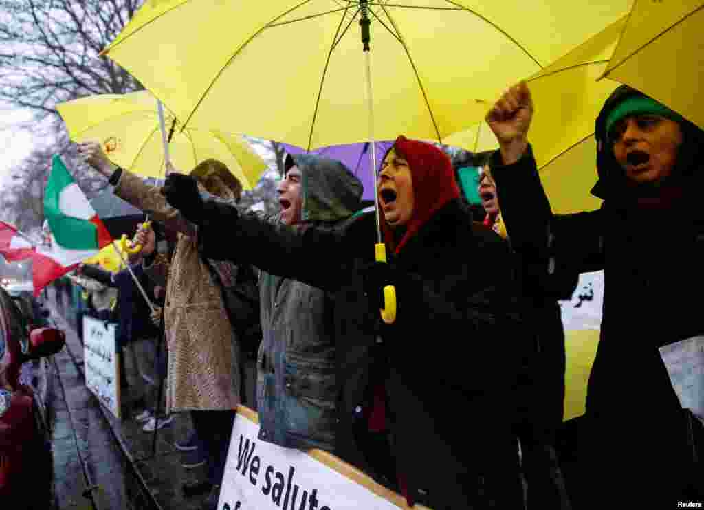 Opponents of Iranian President Hassan Rouhani hold a protest outside the Iranian embassy in west London, Dec. 31, 2017. 