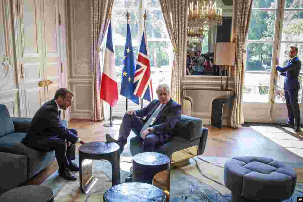 French President Emmanuel Macron, left, talks to Britain&#39;s Prime Minister Boris Johnson during their meeting at the Elysee Palace in Paris.
