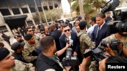 Le Premier ministre libyen Fayez al-Sarraj s'entretient avec les médias devant le bâtiment de la commission électorale après l'attentat-suicide à Tripoli, en Libye, le 2 mai 2018.