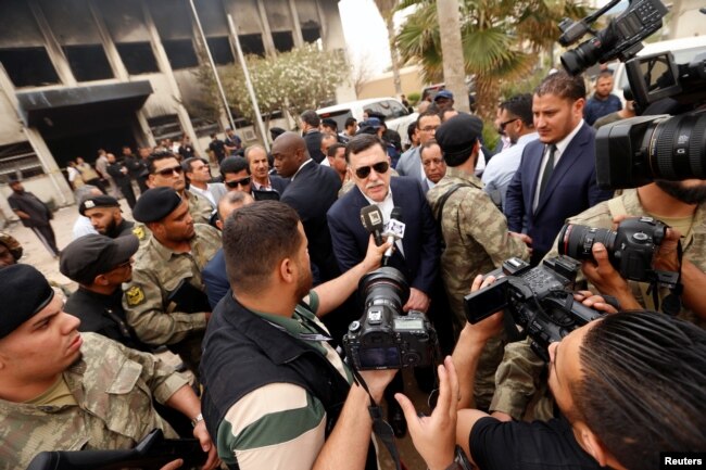 Libyan Prime Minister Fayez al-Sarraj talks to media in front of the electoral commission building after the suicide attack in Tripoli, Libya, May 2, 2018.