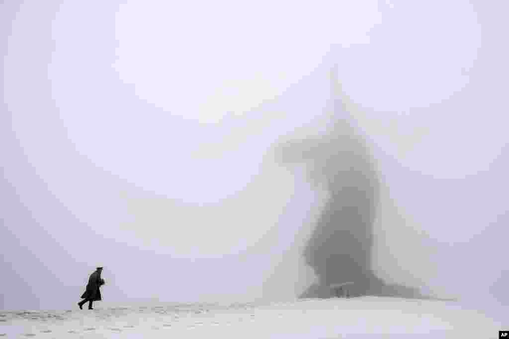 A man dressed in a Red Army World War II uniform walks toward the monument to the Motherland during ceremonies marking the 72nd anniversary of the Battle of Stalingrad in the southern Russian city of Volgograd, former Stalingrad.