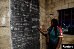 An election worker counts votes during the presidential election in Yaounde, Cameroon, Oct. 7, 2018.