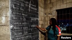 An election worker counts votes during the presidential election in Yaounde, Cameroon, Oct. 7, 2018.