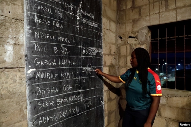 An election worker counts votes during the presidential election in Yaounde, Cameroon, Oct. 7, 2018.