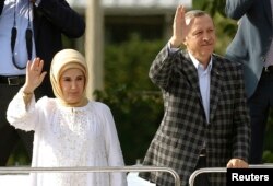 Turkey's Prime Minister Tayyip Erdogan waves to his supporters next to his wife Emine Erdogan in Ankara, June 9, 2013.
