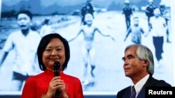 Photojournalist Nick Ut and Kim Phuc (L) attend the presentation of the latest Leica equipment at Photokina 2012, the world's largest fair for imaging, in Cologne, Germany, Sep. 17, 2012. Ut took the iconic 1972 Vietnam War photograph of Kim Phuc running naked down a road after being burned in a napalm attack near Trang Bang. 