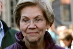 FILE - In this March 5, 2020, file photo, Sen. Elizabeth Warren, D-Mass., speaks to the media outside her home in Cambridge, Mass., after she dropped out of the Democratic presidential race.