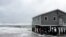Waves wash ashore hitting a house as winds and storm surge from Tropical Storm Maria lash North Carolinas Outer Banks as the storm moves by well off-shore on Wednesday, Sept. 27, 2017. Dare County officials said the high tide flooded some roads in the area and travel is hazardous.