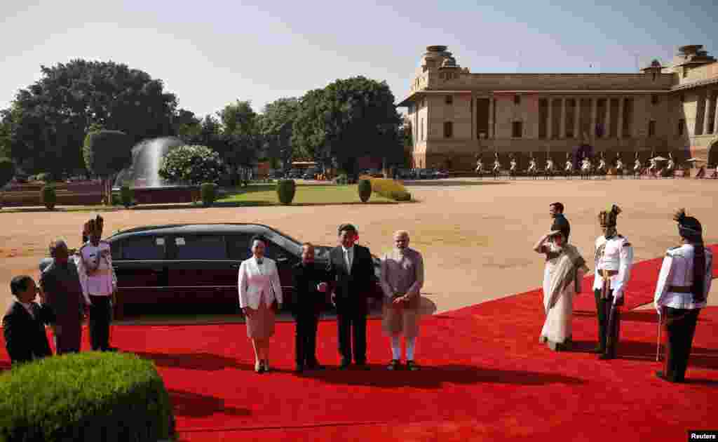 Chinese President Xi Jinping (center, 2nd right) shakes hands with his Indian counterpart Pranab Mukherjee (2nd left) as Xi&#39;s wife Peng Liyuan (center left) and India&#39;s Prime Minister Narendra Modi (center right) look on during Xi&#39;s ceremonial reception at the forecourt of India&#39;s Rashtrapati Bhavan presidential palace, New Delhi, Sept. 18, 2014. 