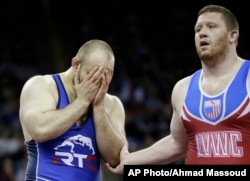 Tervel Dlagnev, left, reacts after beating Zach Rey in their 125-kilogram freestyle finals match at the U.S. Olympic Wrestling Team Trials, April 9, 2016, in Iowa City, Iowa.