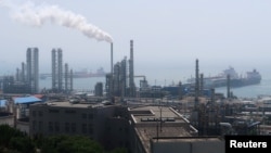 FILE - A refinery is seen near the downtown of Dalian in Liaoning province, China July 17, 2018. REUTERS/Chen Aizhu