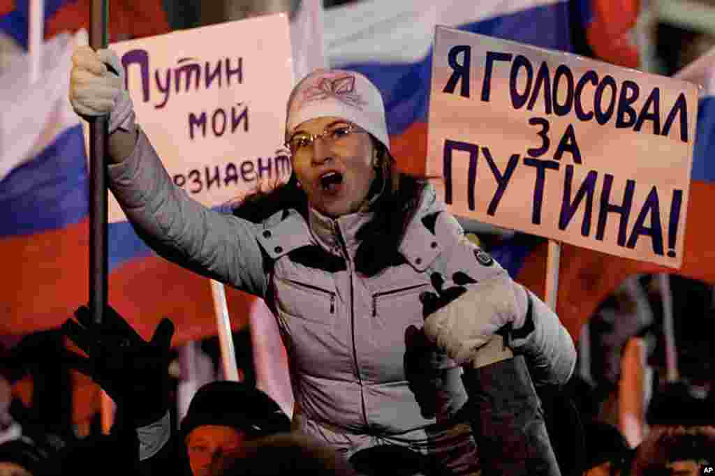 Supporters of Russian Prime Minister Vladimir Putin rally at Manezh square outside Kremlin, in Moscow, Russia, March 4, 2012. Posters read "Putin is my president," "I voted for Putin." (AP) 