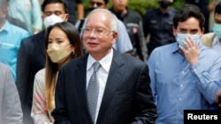 FILE - Former Malaysian Prime Minister Najib Razak walks out from the Federal Court during a court break, in Putrajaya, Malaysia, August 23, 2022.