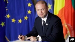 FILE - Malta's Prime Minister Joseph Muscat signs a declaration during an EU summit meeting in the Palazzo dei Conservatori in Rome, March 25, 2017. Malta’s Prime Minister Joseph Muscat called elections for June 3, a year early, to test his popularity amid a scandal swirling around his family and aides.