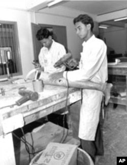 Technicians in Cambodia manufacture prosthetic leg for use by a landmine survivor
