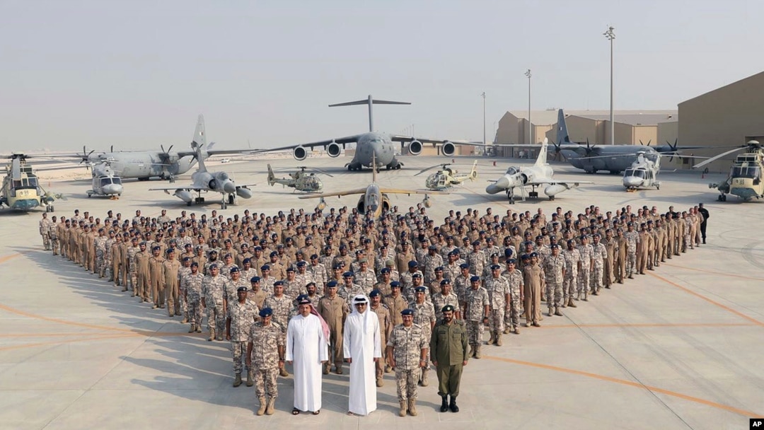 Qatar military facility showing aircraft and personnel demonstrating international military cooperation