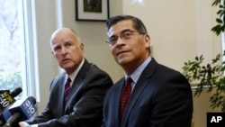  Gov. Jerry Brown, left, and Rep. Xavier Becerra, D-Calif., the governor's nominee for state attorney general, listen to a reporter's questions in Sacramento, Calif. California and other states are weighing legal fights against some of Donald Trump's stated plans.