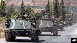 Lebanese army reinforcements arrive to the outskirts of Arsal, a predominantly Sunni Muslim town near the Syrian border in eastern Lebanon, Aug. 4, 2014.
