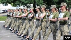 A handout photograph taken and released by the Ukrainian Defence ministry press-service on July 2, 2021 shows the Ukrainian female soldiers wearing heels while taking part in the the military parade rehearsal in Kyiv.