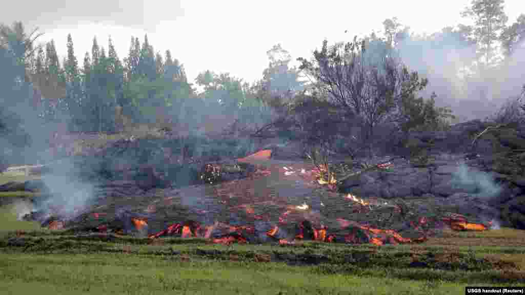 A breakout occurs from an inflated lobe of the Kilauea volcano lava flow near the village of Pahoa, Hawaii, Nov. 2, 2014. 