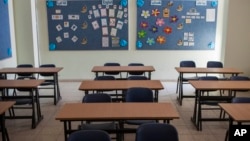 FILE - Image of an empty classroom at a Christian school. Alabama's reigning Teacher of the Year says she resigned after state officials told her she's unqualified to teach in her fifth-grade classroom.