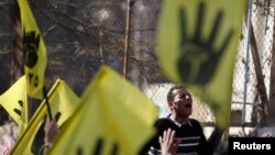 Muslim Brotherhood member shouts anti-military slogans in front of Al Rayyan mosque after Friday prayers, southern suburb of Maadi, Cairo, Dec. 27, 2013.