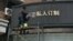 FILE - A worker removes part of a sign that consists of the Chinese characters that collectively read South Korea, at a shop in Shanghai, China, March 15, 2017