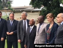 FILE - Burundi's first Vice President Gaston Sindimwo, third from right, and U.S. Ambassador to the United Nations Samantha Power take a photograph at his residence in Bujumbura, Jan. 22, 2016.