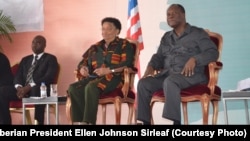 From left, Liberian Defense Minister Brownie Samukai, Liberian President Ellen Johnson Sirleaf and Ivory Coast President Alassane Ouattara attend the Joint Council of Chiefs and Elders Meeting in Guigloe, Ivory Coast, Jan. 18, 2016.