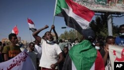 FILE - Thousands of protesters took to the streets to renew their demand for a civilian government in the Sudanese capital Khartoum, Nov. 25, 2021. 