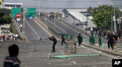 FILE - Indonesian police take position during a clash with supporters of Indonesian presidential candidate Prabowo Subianto in Jakarta, Indonesia, May 22, 2019.