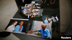 Pictures of Liu Guolian's father Liu Qian, who was a forced labourer by Mitsui Mining to work in their mines in Fukuoka of Japan, are seen on a table during an interview with Reuters on the outskirts of Beijing, April 28, 2014.