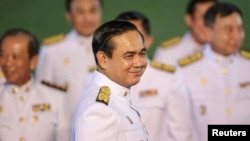 In this file photo, Thailand's Prime Minister Prayuth Chan-ocha and his cabinet complete a photo session after meeting with King Bhumibol Adulyadej in Bangkok September 4, 2014.