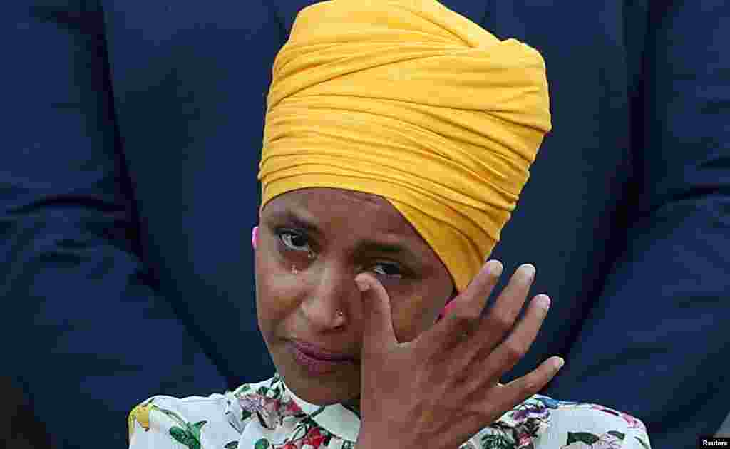 Rep Ilhan Omar (D-MN) wipes her tears as members of Congress observe a moment of silence for the 600,000 American lives lost to COVID-19, outside the U.S. Capitol in Washington, June 14, 2021.