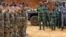 French soldiers stand near Ivorian soldiers in Toumodi, during a military training ahead of the departure of Ivorian soldiers for Mali, Apr. 6, 2013.