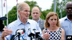 U.S. Sen. Bill Nelson, with U.S. Representative Debbie Wasserman Schultz, right, speaks during a news conference in front of the Homestead Temporary Shelter for Unaccompanied Children, June 23, 2018, in Homestead, Fla. Nelson and four of the state's Democratic House members toured the detention center where about 100 immigrant children taken from their parents were being held. 